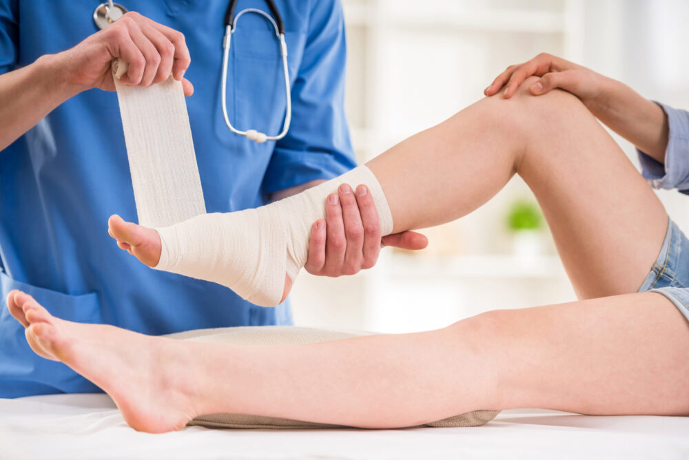Woman getting foot and ankle sports injury treated.